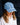 Embroidered Denim Cap featuring mid-wash cotton denim with embroidered daisies and an adjustable strap in a lifestyle view.