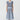 Front view of the Evlyn Knit Top in blue/choc featuring a ribbed v-neckline, dropped armholes with ribbed cuffs, and a contrast tiny square pattern.