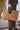 Faly Bag in light brown worn as a stylish large straw tote for everyday use.