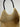 Faly Bag interior pocket detail showcasing the brand label and spacious woven lining.
