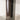 Close-up texture view of the slender, grounded cylindrical iron base.
