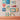 Fun House Tile Kids playful capiz wall art pieces featuring various styles and designs shown displayed together on a styled gallery wall.