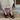 Front view of the Gala Wedge in black leather showcasing its leather upper, open toe, and delicate ankle strap styling.