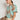 Side angle view of the Hail Top in mint kgari featuring a button-through design and short gathered sleeves.