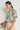 Side angle view of the Hail Top in mint kgari featuring a button-through design and short gathered sleeves.