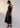 Hali Dress Black side view featuring a relaxed fit through the body and topstitch detailing throughout.