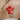 Hanging Angel in red crafted from ceramic with natural twine shown in a front view.