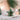 Hanging Star in green crafted from ceramic with natural twine shown in a close up view.