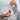 Hanging Star in red crafted from ceramic with natural twine shown being held.