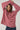 Person wearing a red and white striped sweater on a plain background