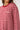 Red and white striped long-sleeve shirt worn by a person on a white background