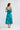 Full-length back view of a model wearing the Heather Dress in Bloomsbury Floral highlighting its shirred back panel.