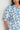 Heir Dress close-up view highlighting the blue botanical print, classic shirt collar, loop trim detail at the neckline, and blouson sleeves with deep cuffs.