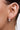 Model wearing the silver Holly mini double row bauble hoop earring on the earlobe.