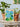Canvas print of blue flowers and green leaves on a wooden table with potted plants.