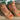 Front close-up view of the Inclination Wedge in cinnamon raffia featuring a two-tone textured upper with signature knot detail and fine ankle strap.