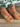 Front close-up view of the Inclination Wedge in cinnamon raffia featuring a two-tone textured upper with signature knot detail and fine ankle strap.