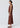 Innes Bias Skirt in Toffee shown from the side, featuring a luxe viscose satin finish, flat elasticised waist, sleek bias silhouette, and midi length.