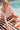 Isabella Shirt Pink lifestyle poolside close-up view showcasing its romantic embroidered design, button-through front, and breathable cotton fabric.