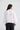 Jenson Shirt in white back view, showing the back yoke pintuck details, relaxed silhouette, and button cuffs.
