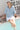 Joanne Shirt Blue poolside lifestyle view highlighting its soft cotton fabric, pop-over style, and relaxed three-quarter sleeves.