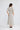 Jocelyn Dress in Ivory Spot shown from the back, featuring an invisible zipper at the back and a fluted hem panel.
