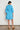 Jostle Dress Lagoon shown from the back profile displaying the relaxed shape and tiered skirt detail.
