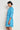 Jostle Dress Lagoon shown from the side profile highlighting the knee length and raglan sleeves.