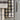 Larder Check Tea Towel featuring a classic check pattern hanging in a kitchen setting.