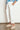 Side angle of the Ledger Jean in elm white crafted in cotton and lyocell, showing a relaxed casual fit, ankle length, and wide cuff at the leg opening.
