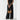 Person holding a tan handbag against a plain background
