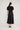 Lucienne Dress Black featuring an invisible zipper at the back and shaped under bust seam viewed from the back.