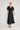 Lucienne Dress Black featuring short sleeves with tuck detail and midi length.