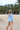 Marigold Reversible Swimsuit sky-blue ribbed side worn on a child viewed from the back at the beach.