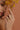 Lifestyle close-up view of a model wearing the gold-plated Maya Ring featuring a trio of bezel-set marquise cubic zirconia stones.