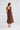 Megan Dress in coffee back view, showing the elasticated back neck edge, midi length silhouette, and gathered shoulder strap details.