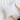 Person holding a white pillow against a light background