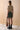 Back view of the Opal skirt in evergreen featuring a mid to high rise waist, structured silhouette, and fully lined 100% rayon interior.