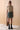 Front view of the Opal skirt in evergreen featuring a structured silhouette, front wrap design, contrast binding, and mini length in 100% cupro fabric.