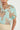 Close-up detail of the Perceive Top in mint kgari showcasing the v-neckline with loop trim.