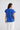 Back view of a model wearing the Percy Top in Cobalt showing its regular fit and hip length.