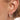 Perla Gold Huggie on-ear view featuring dainty huggie hoops adorned with four tiny pearls in a row.