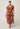 Perla sheer print dress in amber vine worn by a plus-size model, showcasing its flattering flow and relaxed fit.