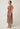 Side view of the Perla sheer print dress in amber vine featuring petal sleeves and a structured collar.