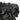 Close-up view highlighting the detailed ruffled petal texture around the rim of the black porcelain bowl.