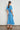 Poem Dress Lagoon shown from the back featuring fluid fabric and a relaxed, elegant shape.