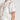 Poem Dress Painterly Bloom crafted in a lyocell linen blend featuring scattered florals, short tulip sleeves, and lace inserts shown in a close up view.