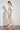Poem Dress Painterly Bloom crafted in a lyocell linen blend featuring scattered florals, short tulip sleeves, and lace inserts shown in a side view.