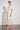 Poem Dress Painterly Bloom crafted in a lyocell linen blend featuring scattered florals, short tulip sleeves, and lace inserts shown in a three quarter view.