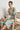 Premier Dress in mint kgari lifestyle view showing the midi length and soft fabric drape.